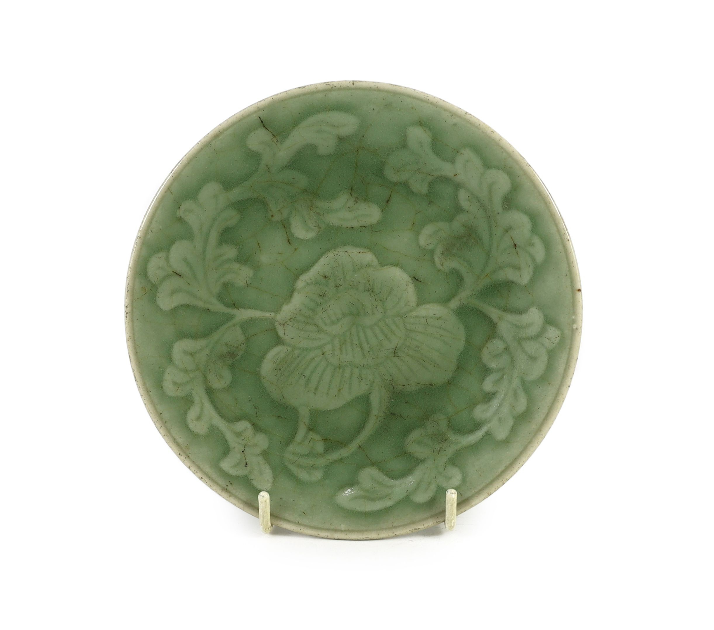 A Chinese celadon glazed small peony dish, Qing dynasty, 14.8cm diameter